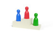 © jroballo - Three pawns on a podium isolated on white background. 3d illustration.