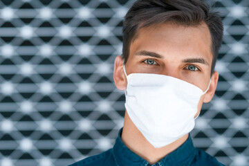 Wall Mural - close up. a young man in a protective mask