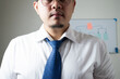 © Igunt - Young Asian businessman Wear a white shirt Tie a blue tie