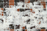 Fototapeta  - fragment of a paved sidewalk covered with snow