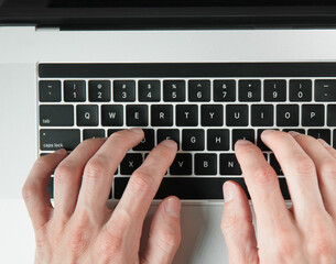 Wall Mural - top view. man typing on a laptop keyboard.