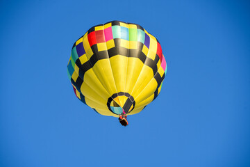 I captired this image one morning this past fall. You can see how the sky would change color as I took pictures from different angles, Hot air balloon floating free.