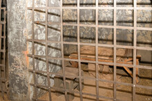 Antique Prison Cell With Bars And Bunks