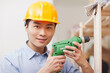 © eastfenceimage - Portrait of young workman using electric drill in office,close-up