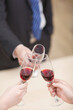© eastfenceimage - Portrait of businessman holding a glass of wine and toasting,close-up
