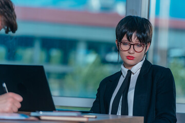 Female manager leads brainstorming meeting. Businesswoman in meeting with colleagues in conference room.