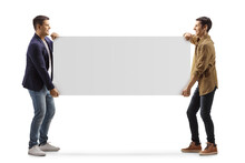 Full Length Profile Shot Of Two Casual Men Carrying A Blank Panel