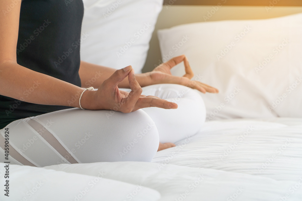 Midsection Of Woman Meditating On Bed At Home - obrazy, fototapety, plakaty 