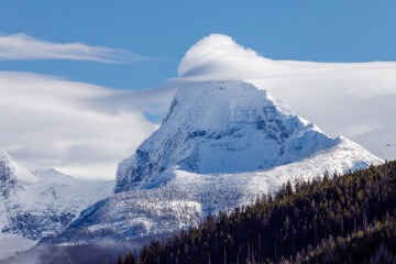 Wall Mural - Cloud covered mountain peak in Glacier Park, Montana in winter