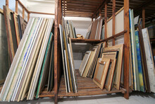 Wooden Shelves At Art Gallery Storage Full Of Pictures And Art Equipment