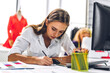 © Art_Photo - Portrait of young beautiful pretty woman fashion designer stylish sitting and working.Attractive young girl use desktop conputer and colorful fabrics at fashion design studio