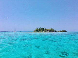 Sailboat anchored off a beautiful Island in Belize off the belize barrier reef