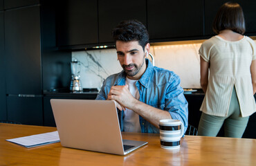 Wall Mural - Young man working from home.