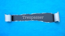 Trespasser. Blue Torn Paper Banner With Text Label. Word In Gray Hole.