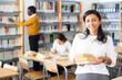 © JackF - Portrait of young adult woman studying in at public library