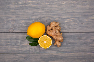 Wall Mural - Lemon and ginger on a wooden background. Ingredients against influenza and viruses. Ingredients for tea. Natural medicine.