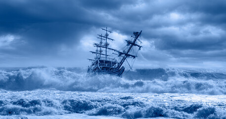 Sailing old ship in a storm sea in the background stormy clouds