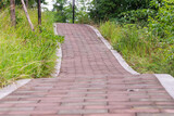 Fototapeta Tęcza - The red brick road in the park