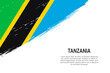 Grunge styled brush stroke background with flag of Tanzania