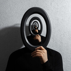 enigmatic surrealistic optical illusion, young man holding round frame on textured grey background.