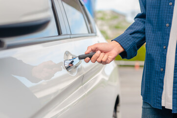 Wall Mural - Man holding key opening car door