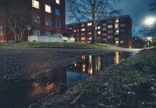 Surface Level Of Puddle By Buildings At Night