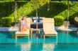 © siraphol - Portrait beautiful young asian woman relax smile leisure on vacation around swimming pool