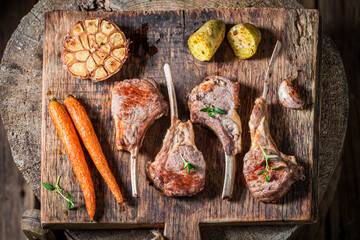 Wall Mural - Top view of roasted lamb ribs with vegetables