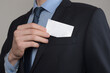 © Ivan - Businessman ,Business Man's hand hold showing business card - close up shot on grey background. Show a blank piece of paper. Paper visit card