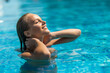 © F8  \ Suport Ukraine - Portrait of beautiful tanned woman in swimwear relaxing in swimming pool spa.
