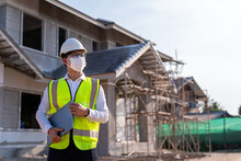 Portrait Of Architect Wearing A Mask Hold A Laptop On A Building Construction Site, Homebuilding Ideas And Prevention Of Coronavirus Disease..