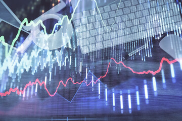 Double exposure of forex chart hologram over desktop with phone. Top view. Mobile trade platform concept.