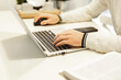 © Olga Gimaeva - A man working on a laptop at home at bright kitchen