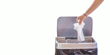 Woman Hand Throwing A White Used Crumpled Tissue Paper Handkerchief Into A Garbage Trash Bin. Health Care And Hygiene Concept,on White Background.