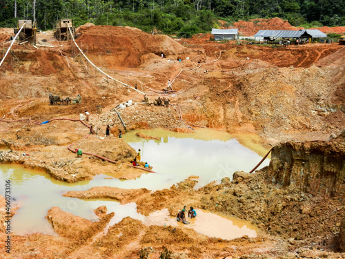 Gold mining place in Guyana, local indigenous people clear workspace from stones and check it for gold nuggets. Amazon Essequibo basin deforestation. Guyana, Brazil, Venezuela gold mining exploration.