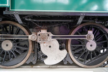 Closeup Of An Old Green Steam Locomotive Wheels