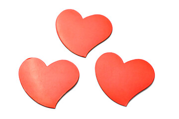 red hearts on a white background, mother's day and valentine's day, top view of three scarlet hearts view over