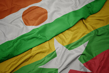 Waving Colorful Flag Of Myanmar And National Flag Of Niger.