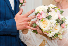 Newlyweds Exchange Rings, Groom Puts The Ring On The Bride's Hand In Marriage Registry Office