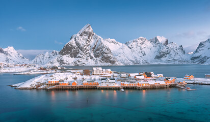 Wall Mural - aerial view of fishing village in surrounded mountain on winter season at sakrisoya island, lofoten,