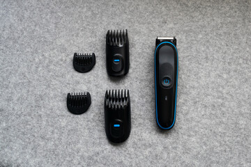 Poster - Hair clipper with accessories on a gray table