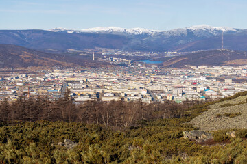 Wall Mural - View from the mountain to the city of Magadan. A large city in a valley among the mountains. Beautiful autumn cityscape. Street and building view. Magadan, Magadan region, Siberia, Russian Far East.