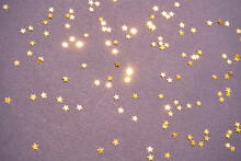 Gold Stars On Purple Background. Yellow Glitter Backdrop. Golden Texture. New Year Luxury Snow. Copyspace. Shimmer Confetti Wallpaper. Dreamy Shiny Design Detail