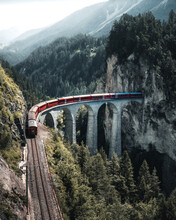 Swiss Train Ridin Over The Landwasser Viaduct Near Filisur, Canton Of Grisons, Switzerland