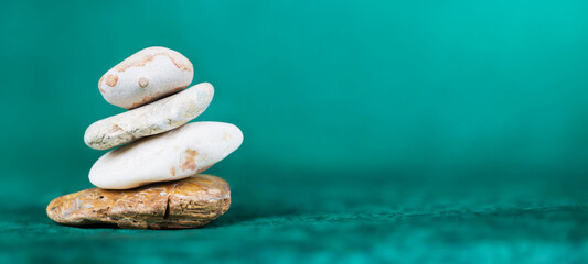 Balance, life coaching, self realization stones on blue background. Web banner with copy space.