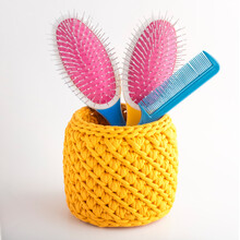 Handmade Yellow Basket With Massage Hair Combs. Texture Of Knitted Fabric Braids. Decorative Element In The Interior