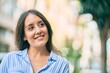 © Krakenimages.com - Young hispanic woman smiling happy standing at the city.