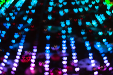 Color Bokeh on a dark background with hearts for use in graphic design