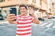 © Krakenimages.com - Young caucasian man smiling happy doing video call using smartphone at the city.