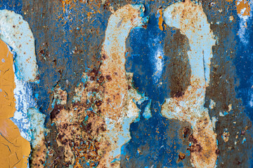 Rust, steel, background. Peeling off old paint Blue yellow white